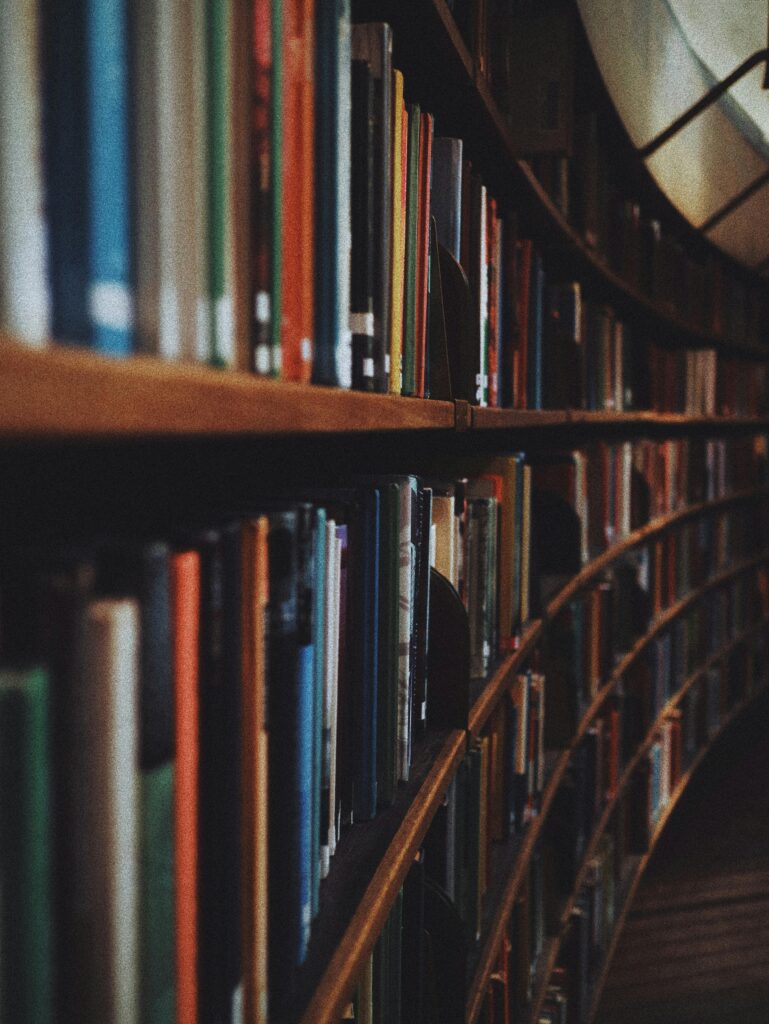 pexels-photo-3646105-3646105 Warm-toned image of curved library bookshelves filled with books in Stockholm.